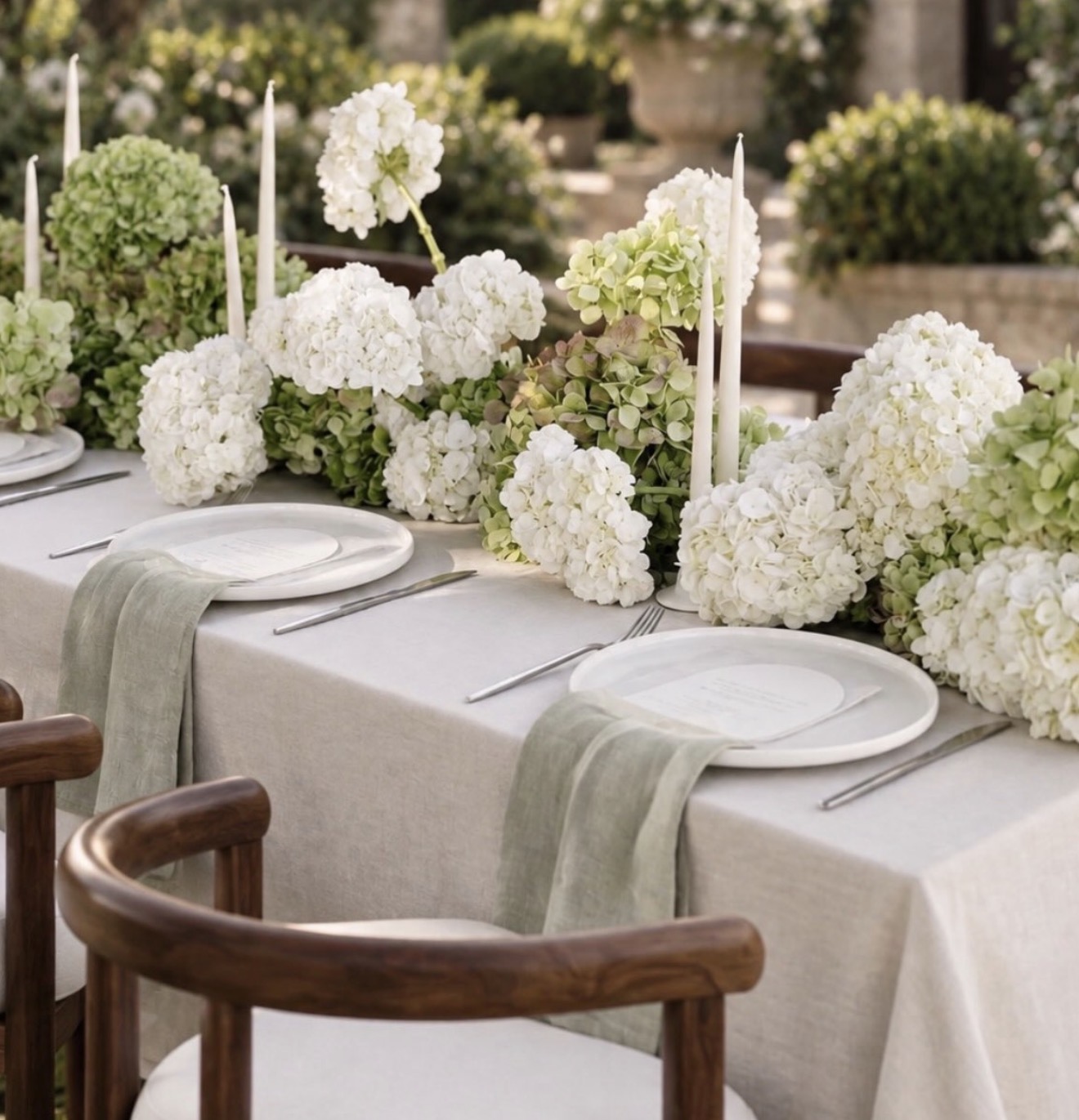 White and green hydrangeas arranged along another view of the engagement party table