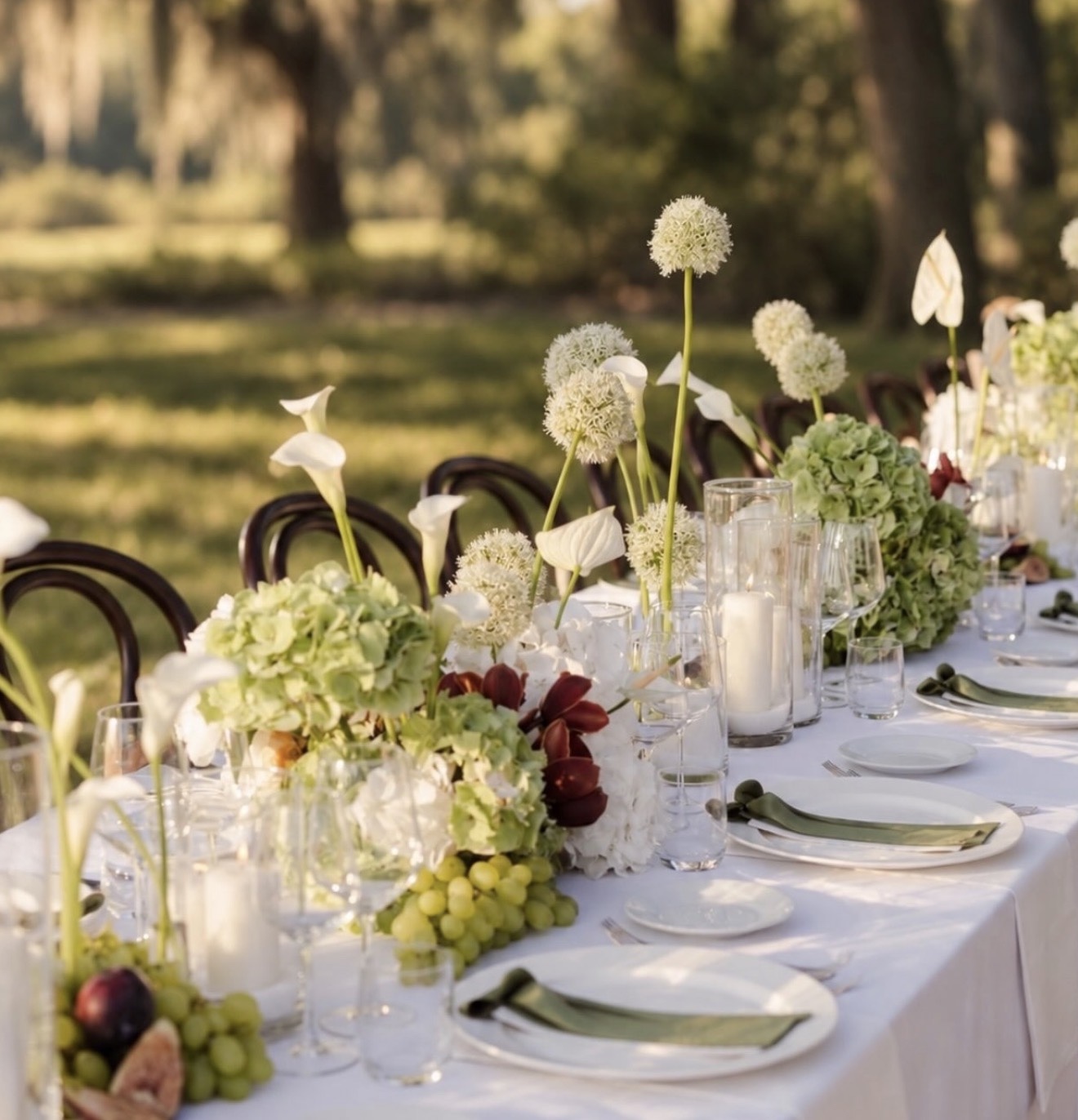Calla lilies, alliums, hydrangeas and candlelight along the Island Park Private Wealth client appreciation table