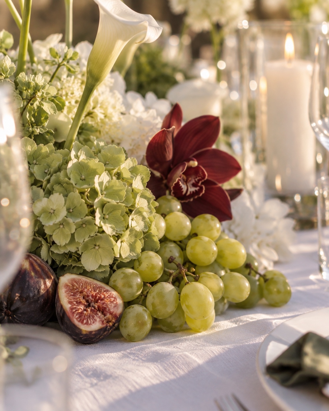 Hydrangea, calla lily, orchid, grapes and figs in the event tablescape