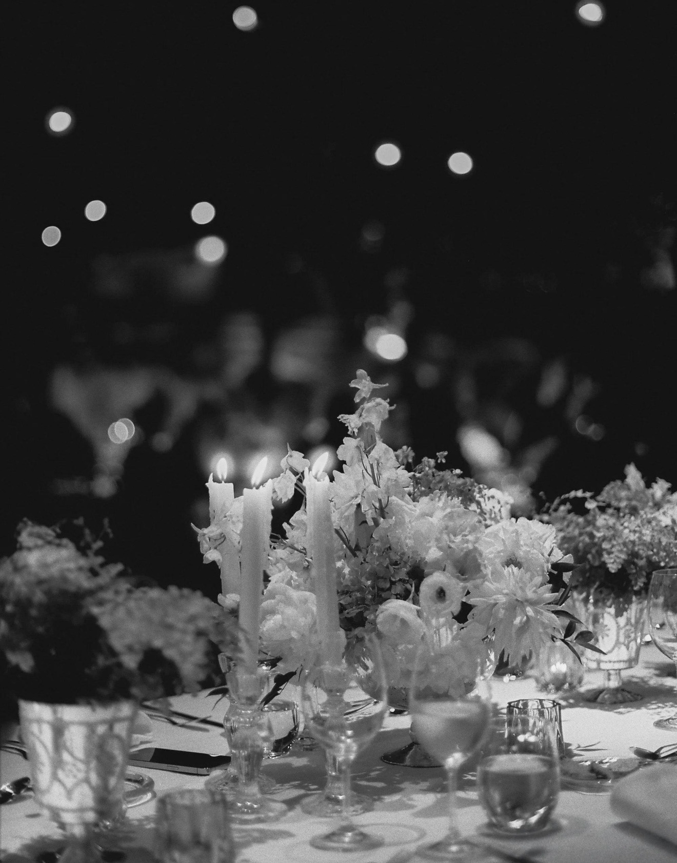 Candlelit wedding table photographed after dark